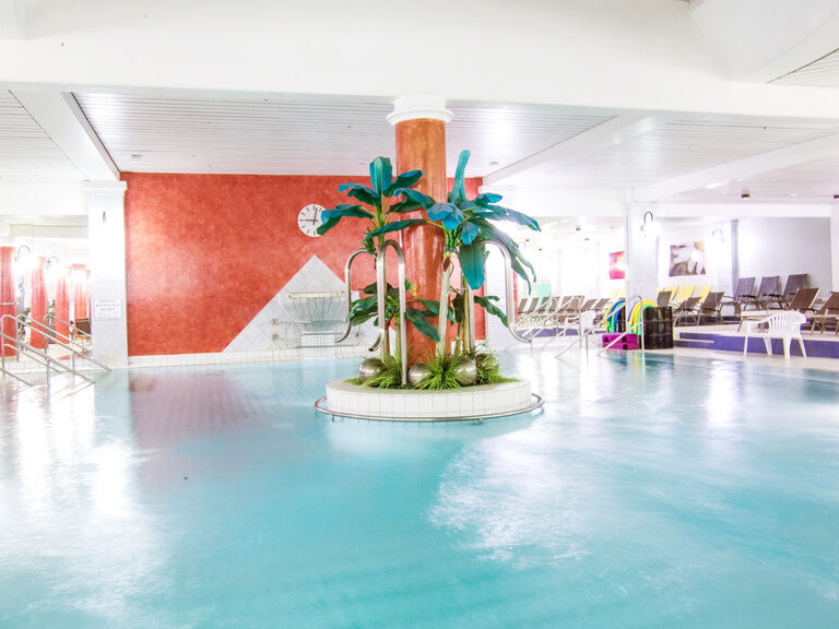 Der große Innenpool mit einer kleinen Palmeninsel in der Mitte